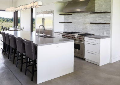 kitchen area - dual oven stove top - island - countertop - ventalation stone backsplash