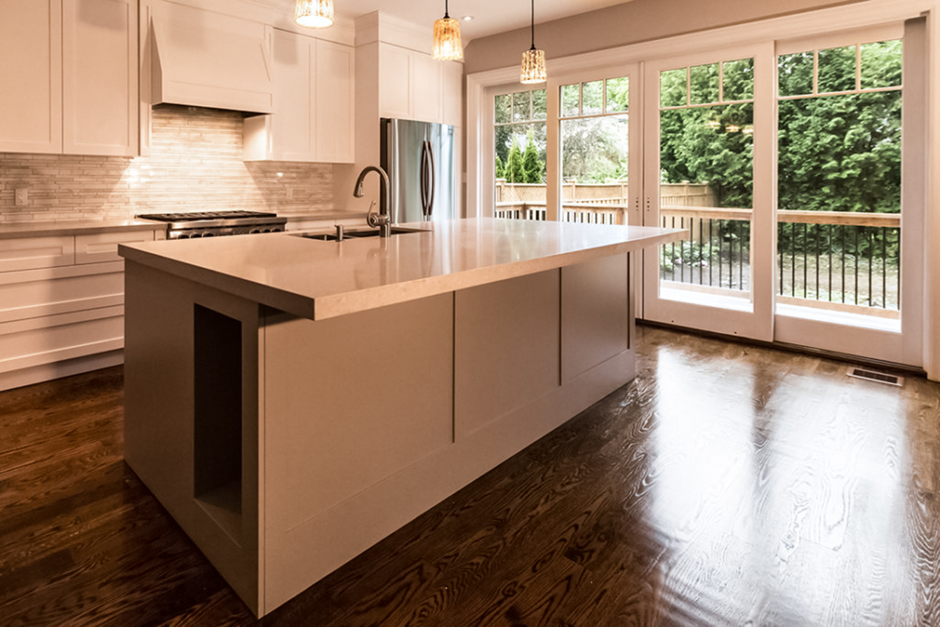 Little Redstone Custom Design and Builds to Suit Your Needs kitchen - island - stovetop - granite counter - stone backsplash - stainless steel refrigerator - patio - glass dorrs - stove fan - tall faucet -